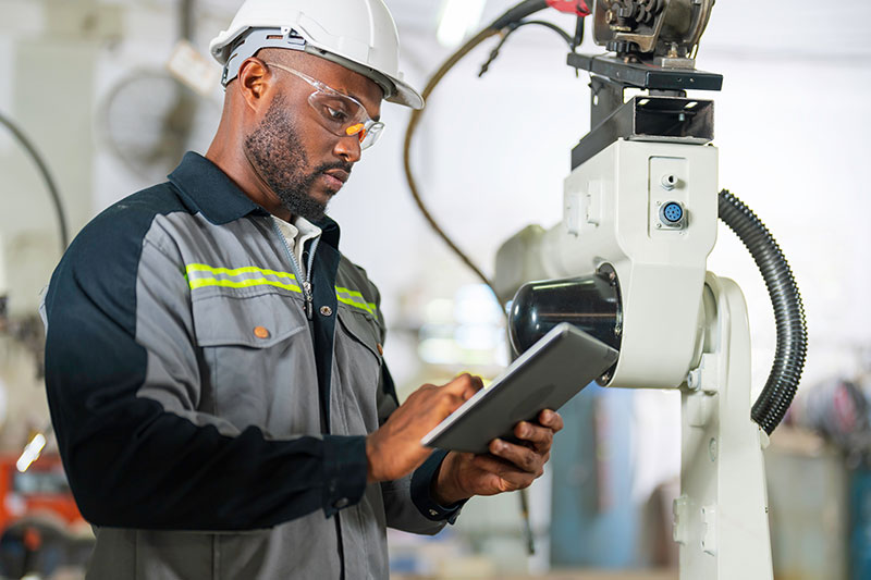 man in smart manufacturing facility on tablet device