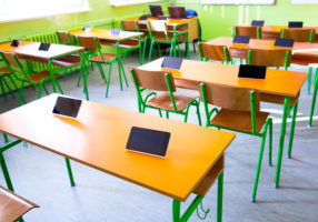 digital tablet on table in classroom at school