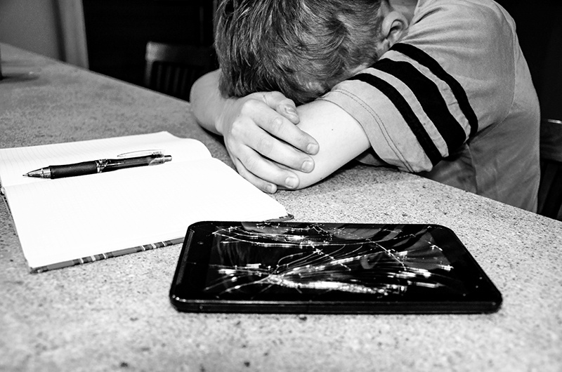 Child next to broken smart device
