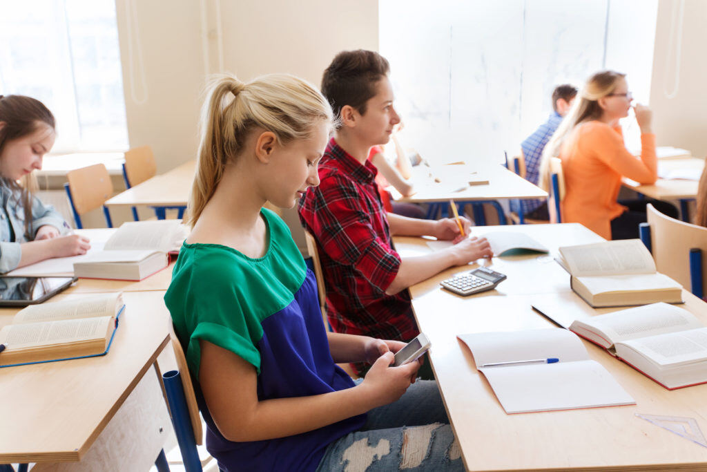 Students in school using cell phone, French cell phone ban | LocknCharge
