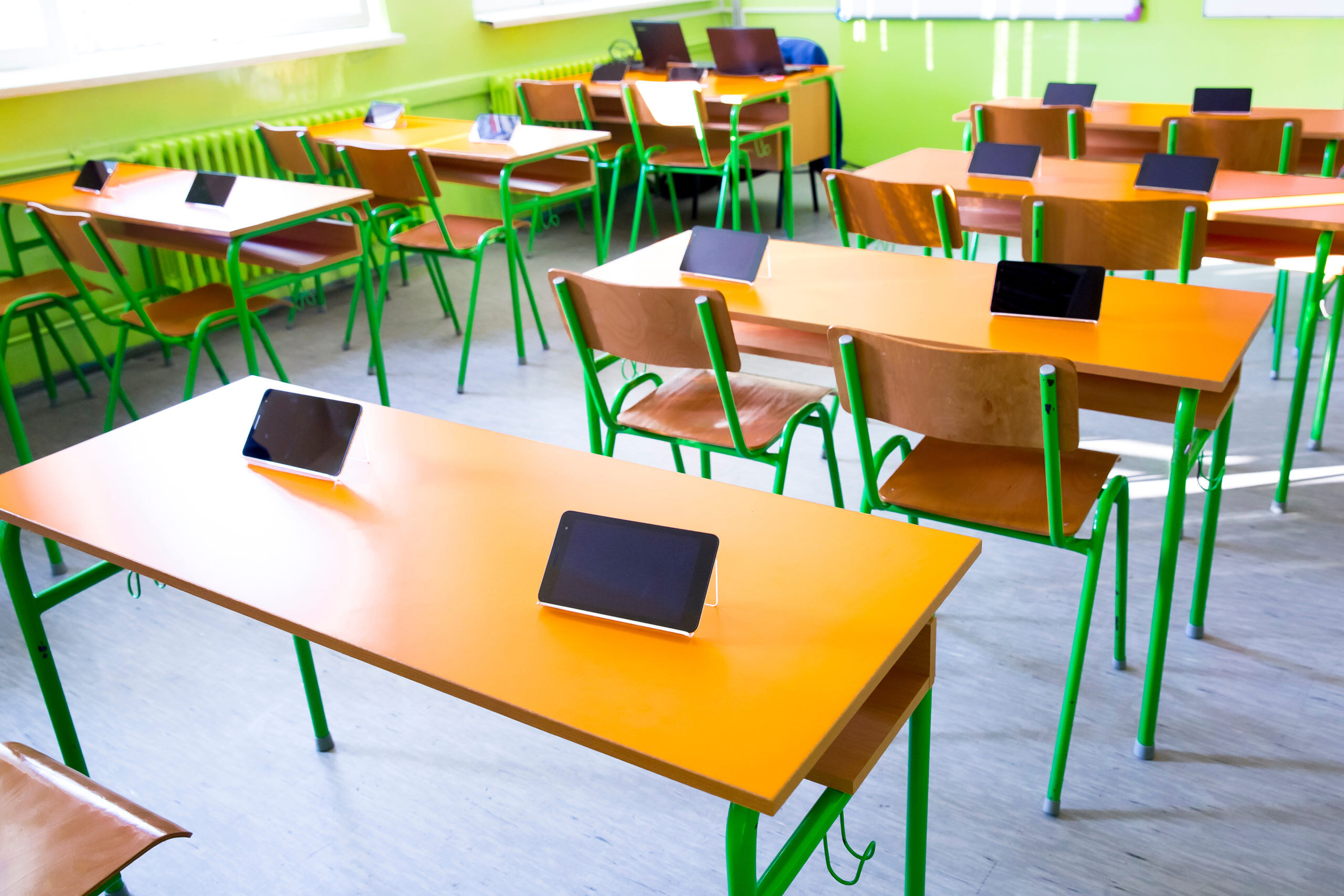 digital tablet on table in classroom at school